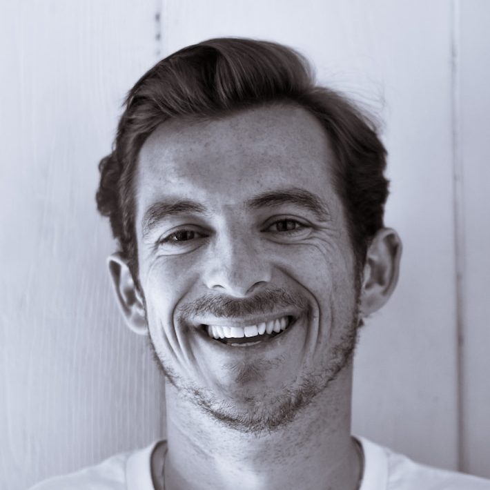grayscale photography of man smiling